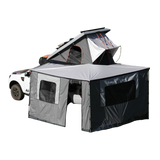 Alu-Cab 270 awning, with the Awning Side Wall Kit and a hard shell rooftop tent, fitted to a camping vehicle