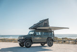 Camp4x4 Suzuki Jimny with a rooftop tent and 2m 270 Shadow awning on a beach