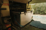 Camper van interior with a storage box and outdoor setup