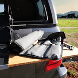 Alu-Cab Cutlery Roll Deluxe on a truck bed with mountains in the background