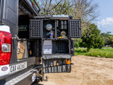 Alu-Cab Cutlery Roll Deluxe on a truck bed with mountains in the background