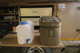 Water container and an ice maker in a storage bag on a table inside a vehicle
