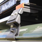 Close up view of a black Alu-Cab Gutter Feet. Standard or Wide Profile. Suzuki Jimny