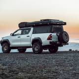 Double Cab Toyota Hilux, fitted with Black Alu-Cab Explorer Canopy, with treaded finish. Camp4x4 camp 4x4, overlanding, camping. extra cab. Gen3.R Rooftop Tent. Roof Box. Spare wheel mount.