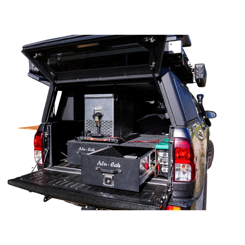Alu-Cab Double Drawer System mounted in an offroad vehicle, fitted with and Alu-Cab Canopy; Gen3 Rooftop tent.